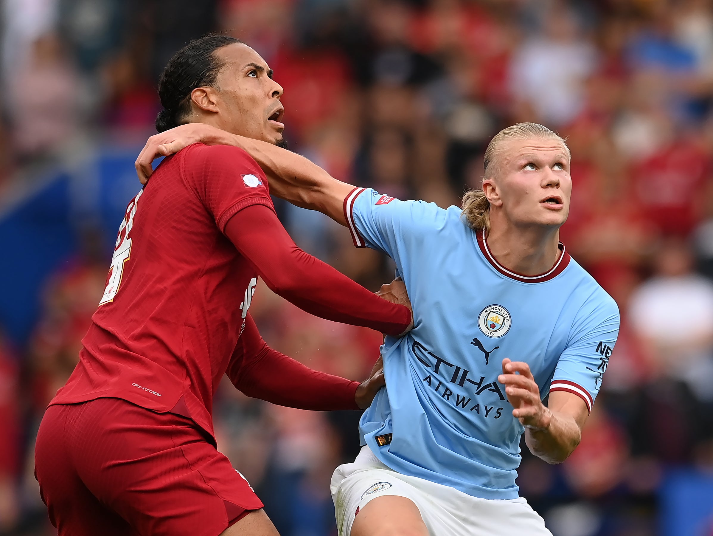 Liverpool defender Virgil van Dijk challenges for the ball with Manchester City striker Erling Haaland