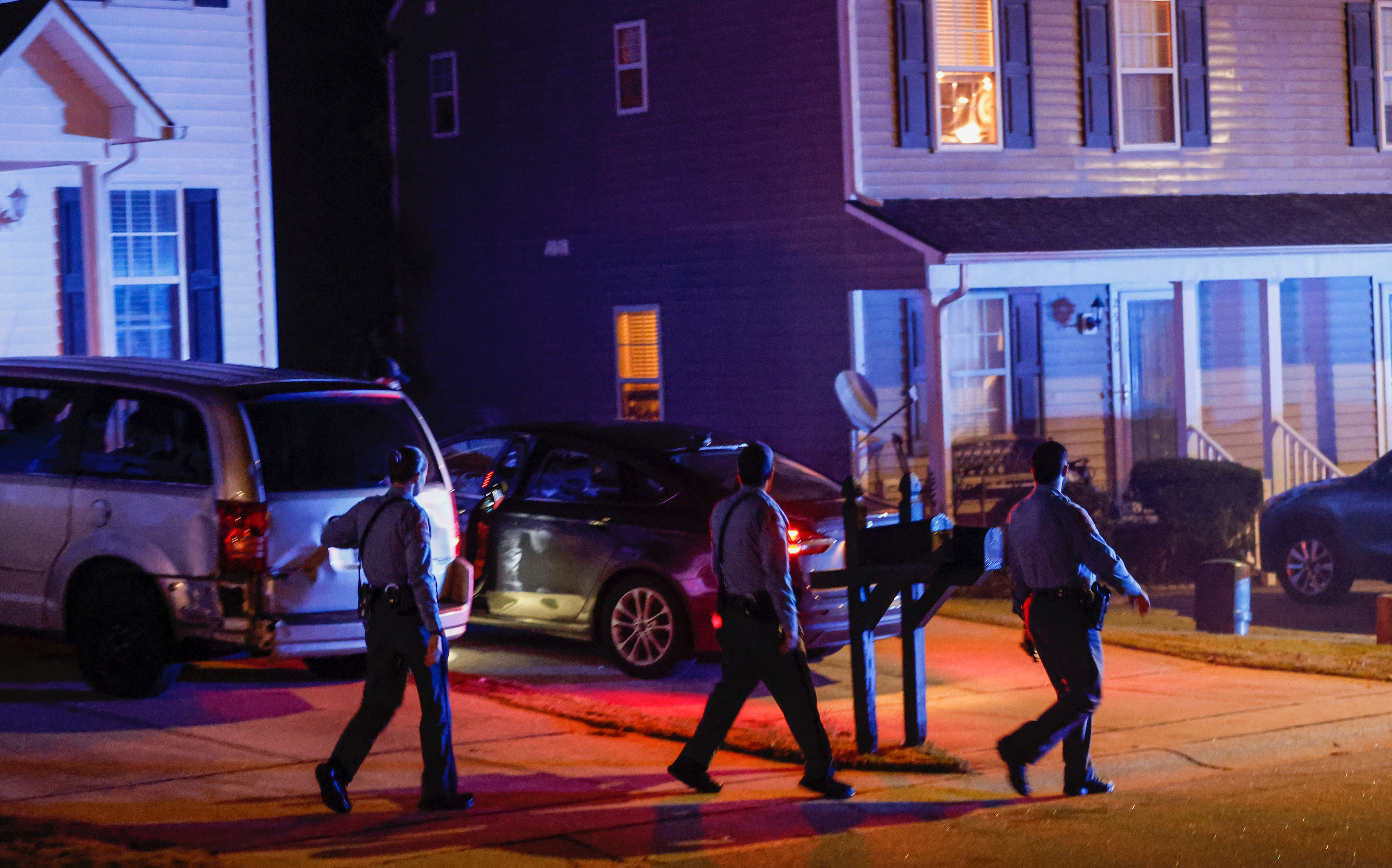 <p>Raleigh Police officers walk door-to-door checking on residents in the Hedingham neighborhood and Neuse River Trail area in Raleigh, N.C., after five people were shot and killed Thursday, Oct. 13, 2022</p>