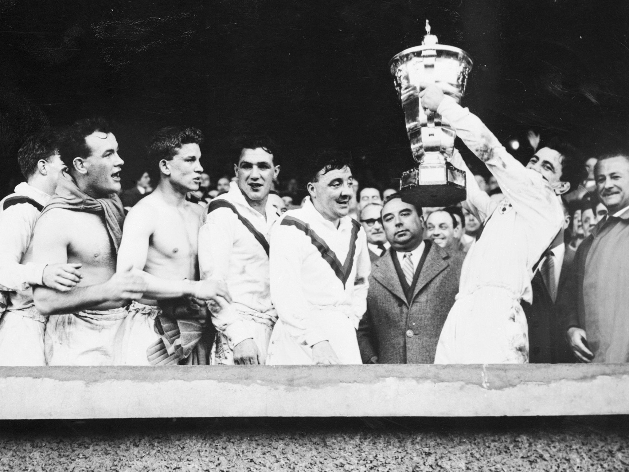 Victorious Great Britain players hold aloft the trophy after winning the inaugural Rugby League World Cup