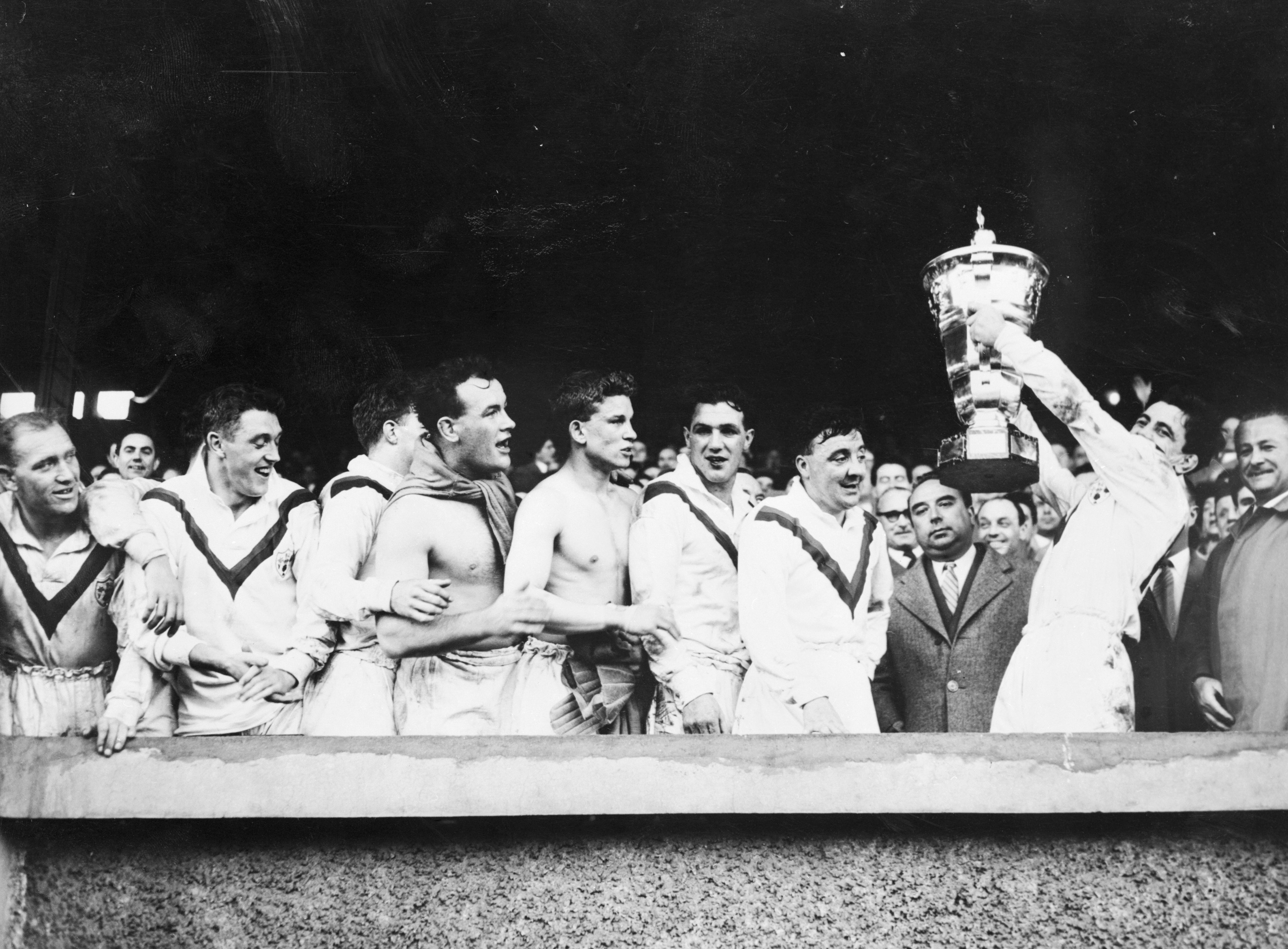 Victorious Great Britain players hold aloft the trophy after winning the inaugural Rugby League World Cup