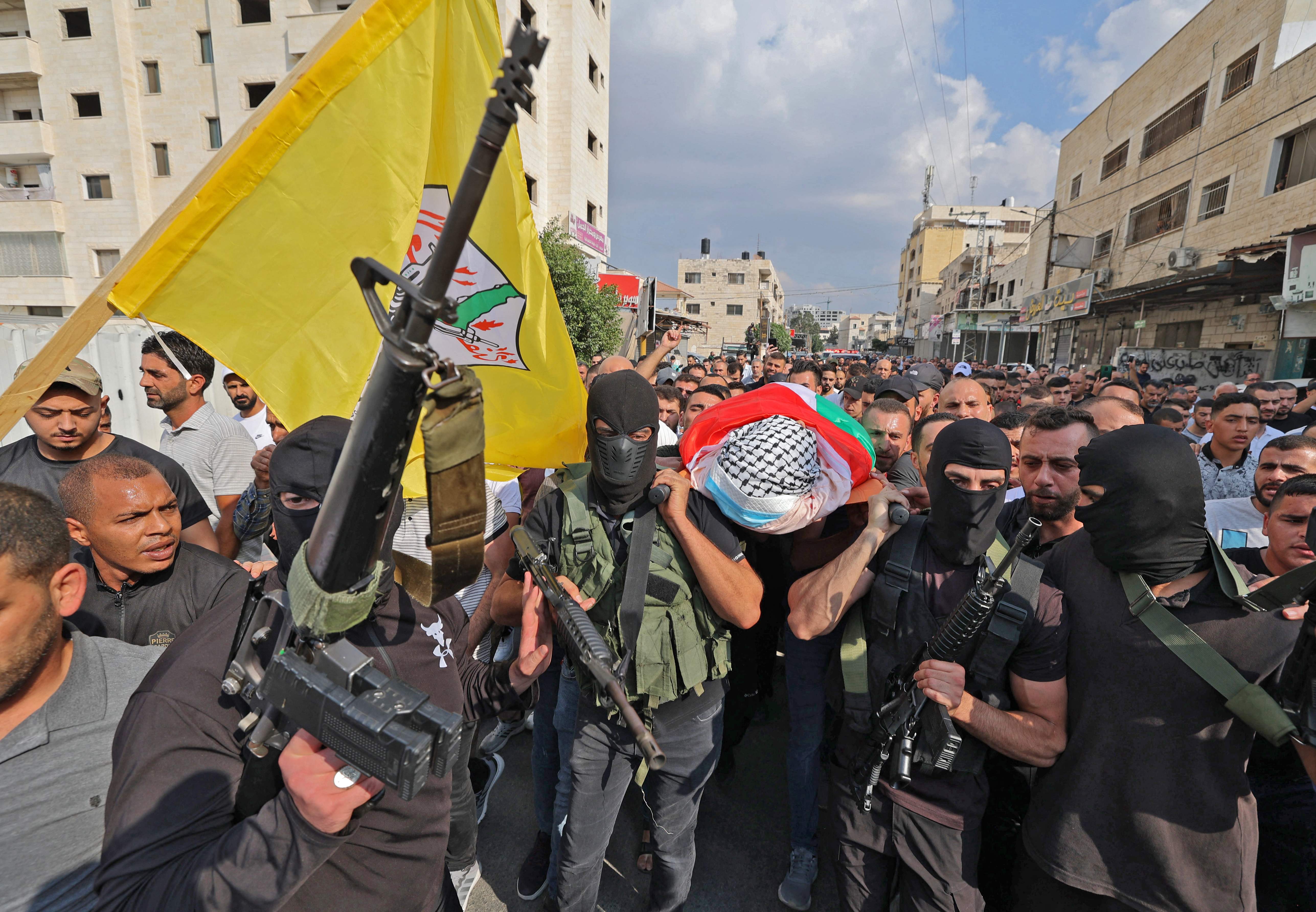 Palestinian mourners carry the body of Abdullah al-Ahmad, a doctor killed during an Israeli raid earlier today, during his funeral in the Jenin refugee camp, near the West Bank city of the same name