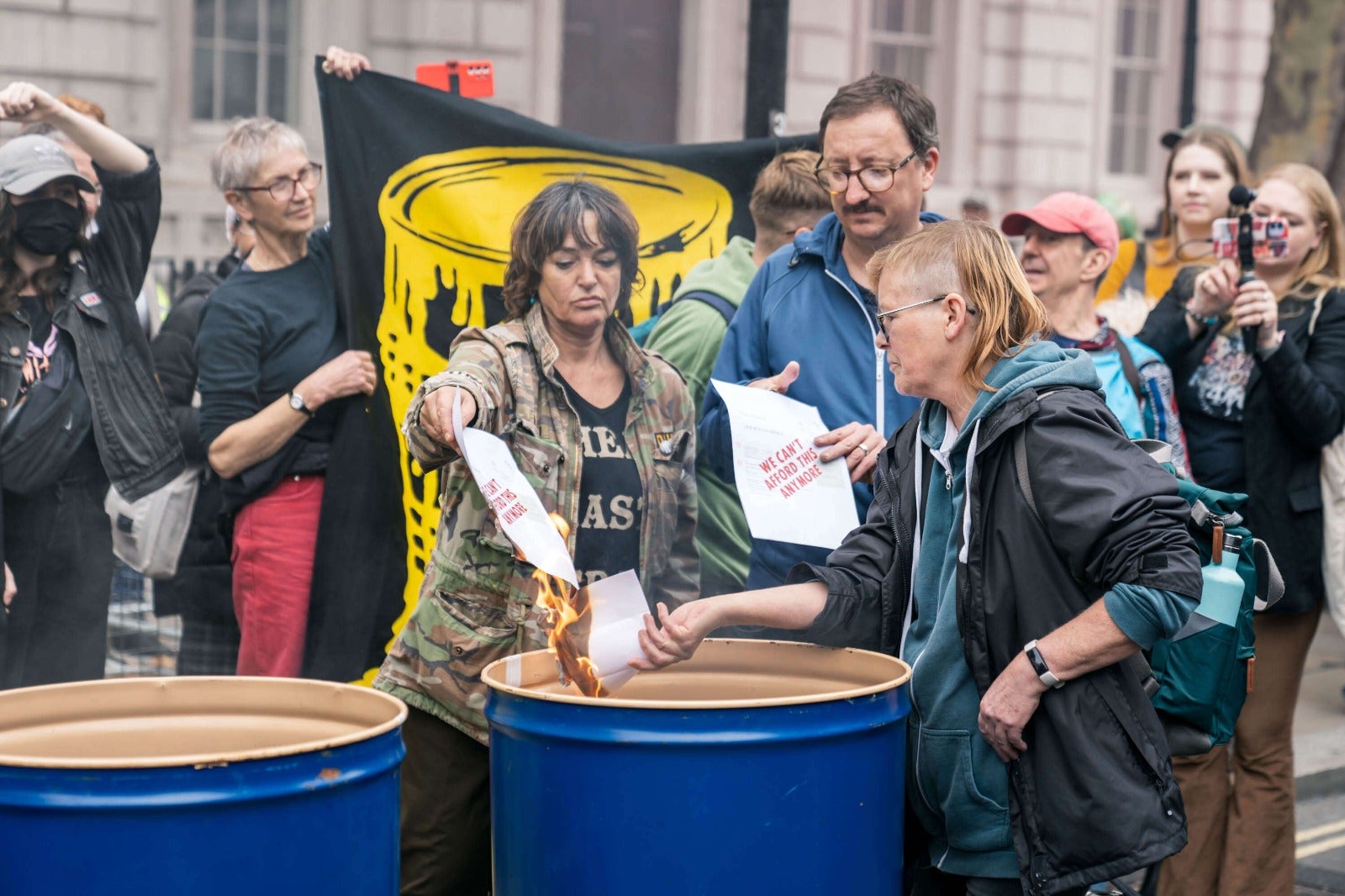 Extinction rebellion activists burn energy bills in Downing Street protest