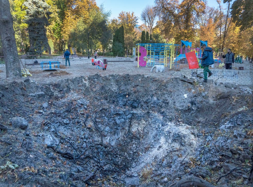 <p>FILE - A man passes past a rocket crater at playground in city park in center Kyiv, Ukraine, Tuesday, October 11, 2022 </p>