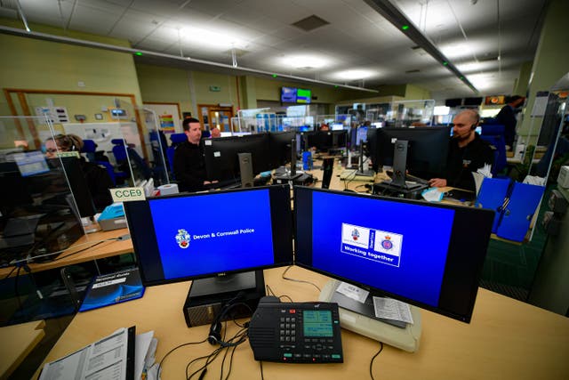 <p>Police staff operate 999 emergency phone lines in the control room at Exeter Police HQ, Devon (PA)</p>