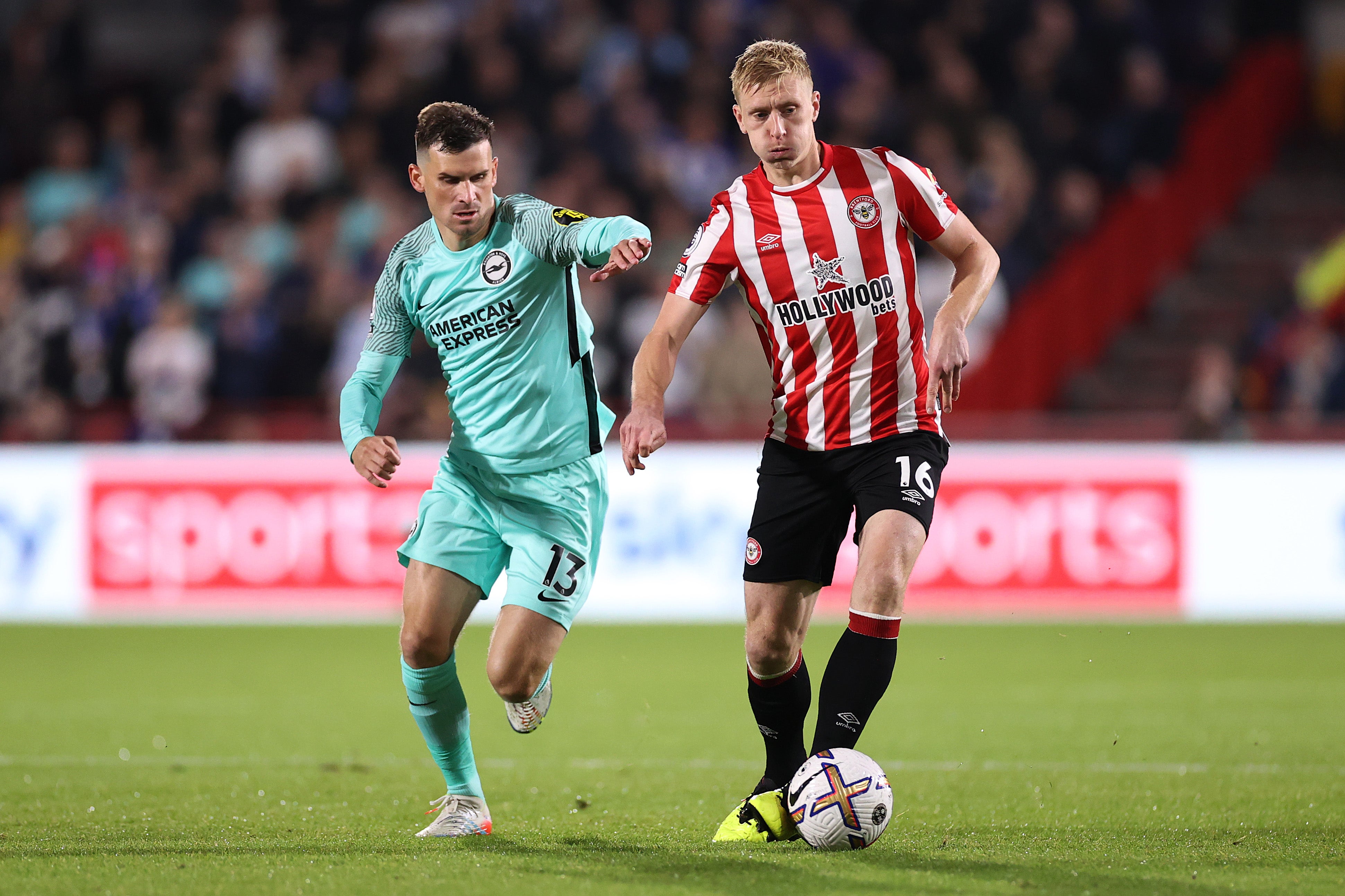 Ben Mee of Brentford is challenged by Pascal Gross of Brighton & Hove Albion