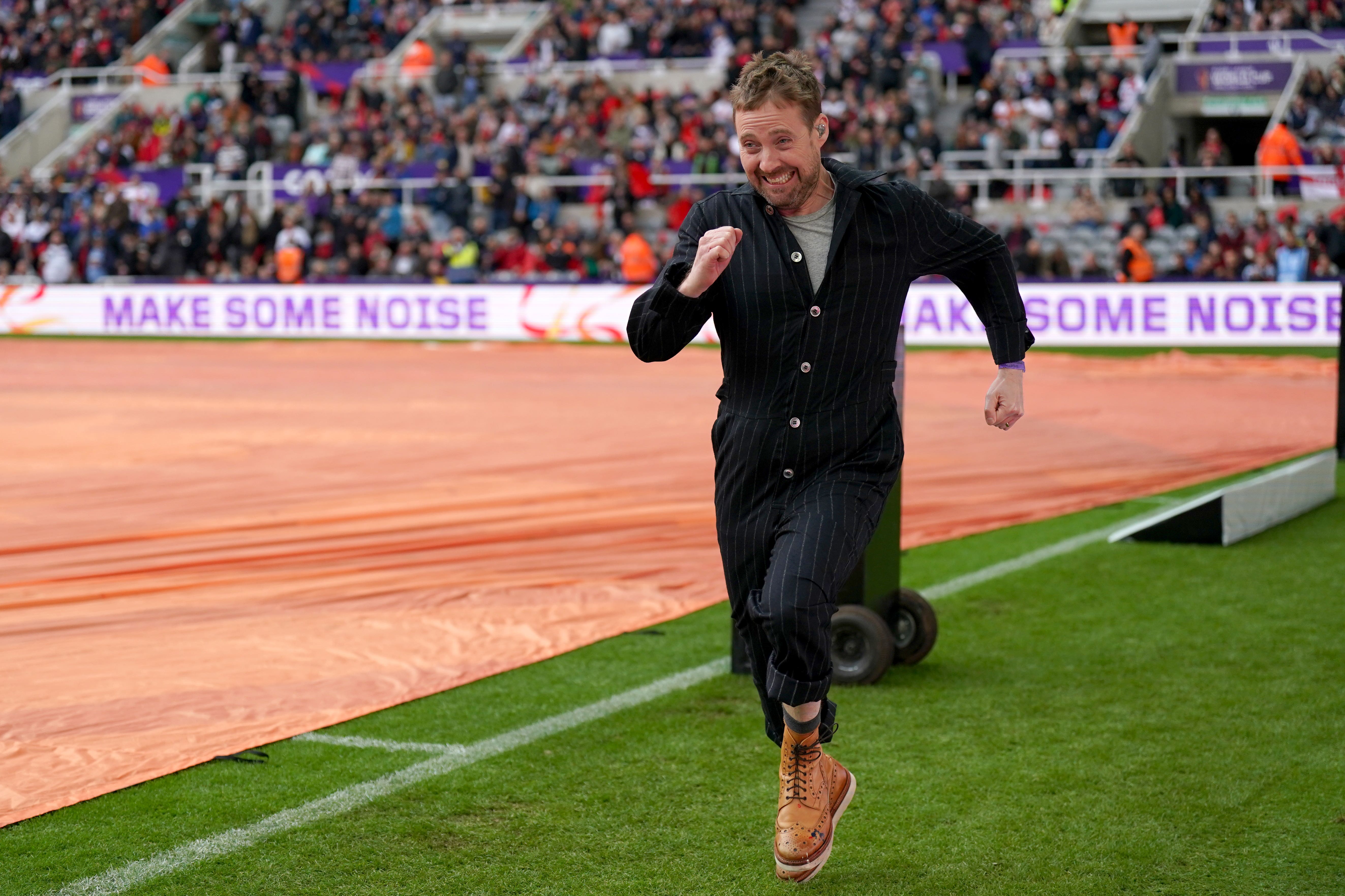 Ricky Wilson of The Kaiser Chiefs entertains the crowd during a delay to the Rugby League World Cup group A match at St James’ Park
