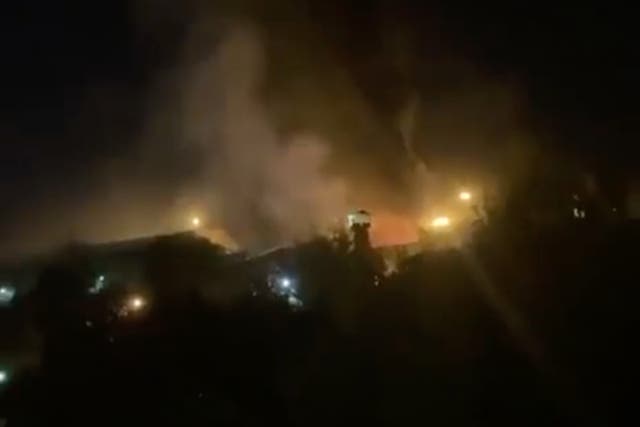 <p>Footage captures the sound of shooting and flames billowing from the site of the prison</p>