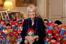 Camilla pictured with dozens of Paddington Bears left as tributes to the Queen