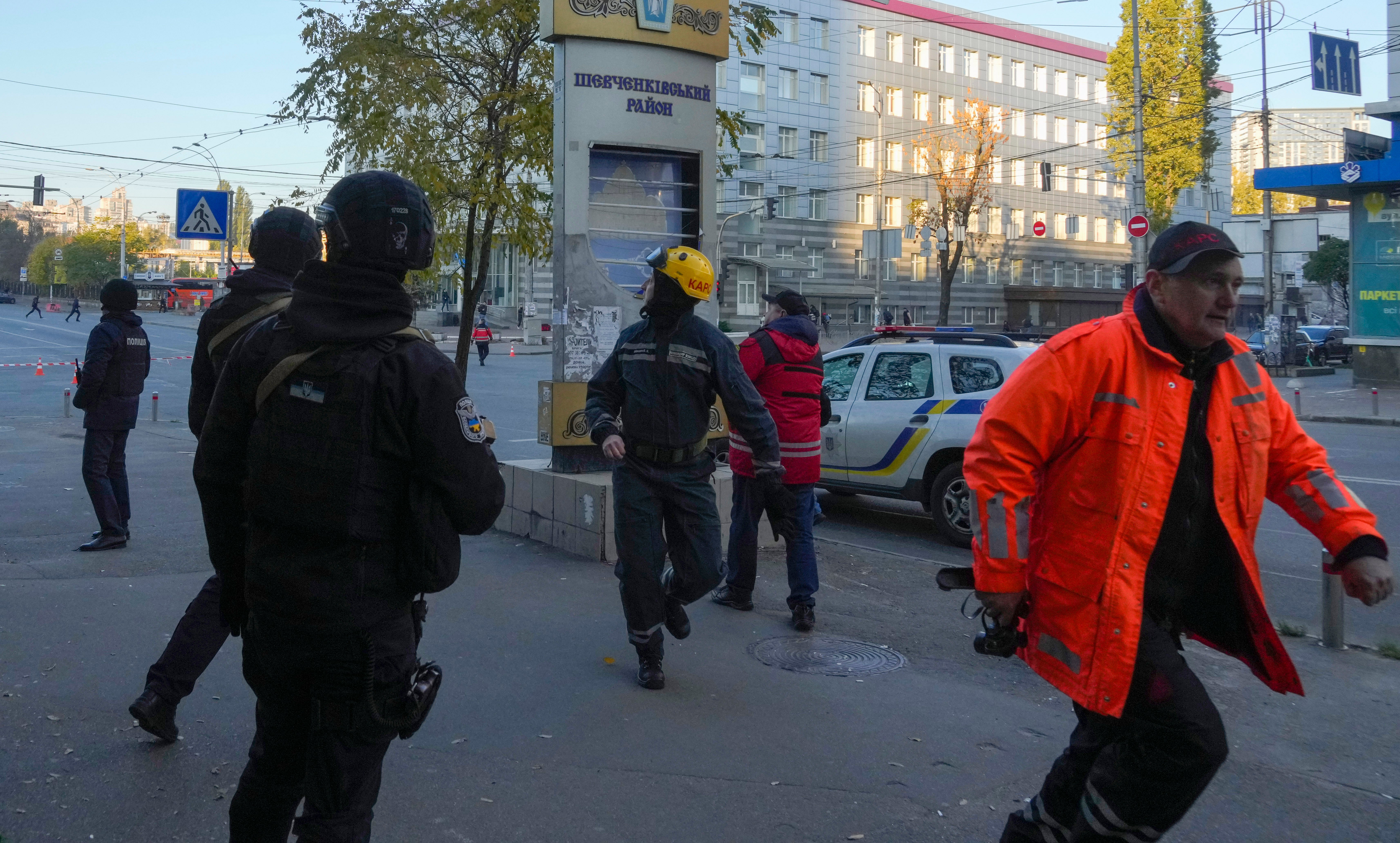 Residents run for cover after a string of explosions rocked Kyiv on Monday
