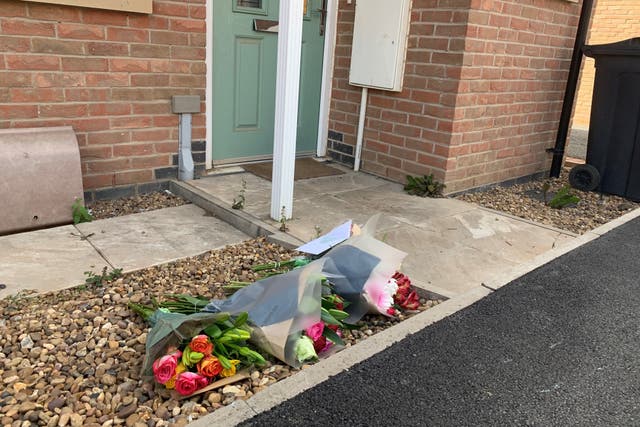 Floral tributes left near to the scene in Field Edge Drive, Barrow upon Soar, where a 28-year-old woman was killed in a suspected hit-and-run (PA)