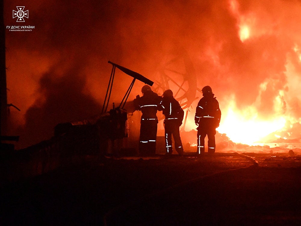 Firefighters at the site of a fire involving sunflower-oil storage tanks in Mykolaiv