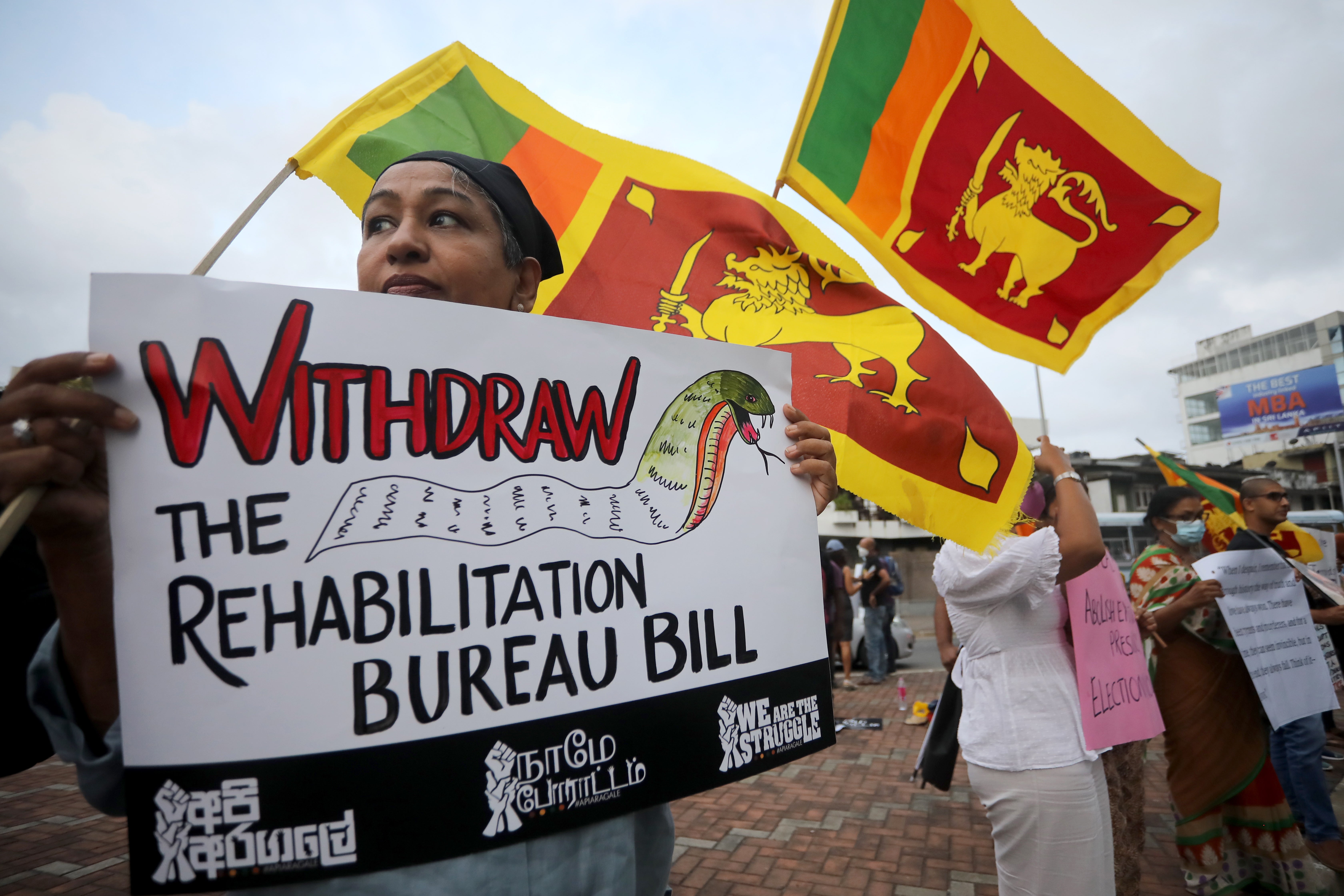 <p>Anti-government protesters hold placards and national flags during a protest against the current economic and political crisis, in Colombo, Sri Lanka, 07 October </p>