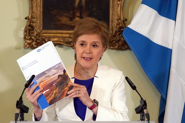 Nicola Sturgeon shows off the prospectus paper (Andrew Milligan/PA)