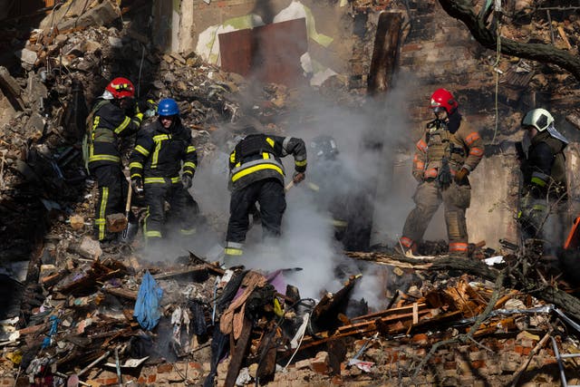 <p>Firefighters attempt to put out a fire in a four-storey residential building after a ‘kamikaze drone’ attack in Kyiv</p>