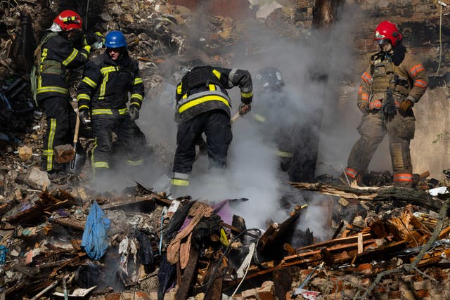 <p>Firefighters appear on the scene to put out a fire in a four-story residential building after a ‘kamikaze drone’ attack</p>