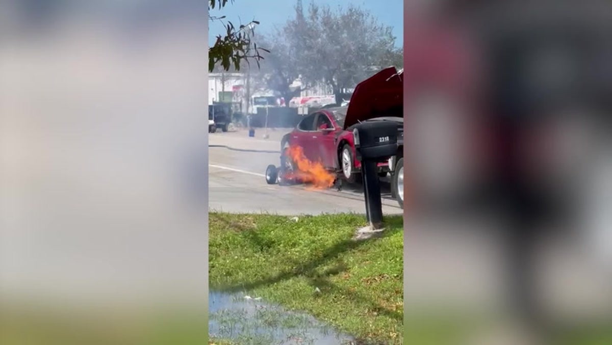 Firefighters douse burning Tesla with water after battery catches fire