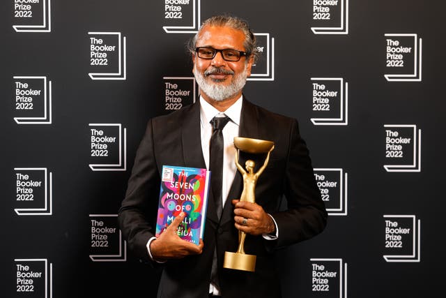 Winning author Shehan Karunatilaka with his trophy and book (David Parry/PA)