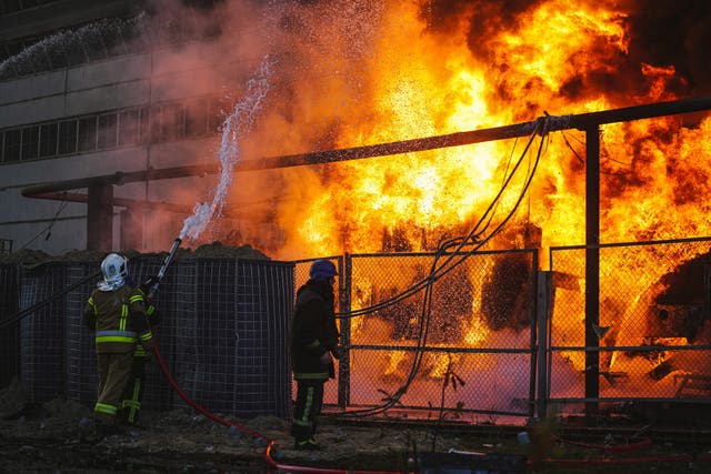 <p>Firefighters work to put out a fire in a thermal power plant, damaged by a Russian missile strike in Kyiv</p>