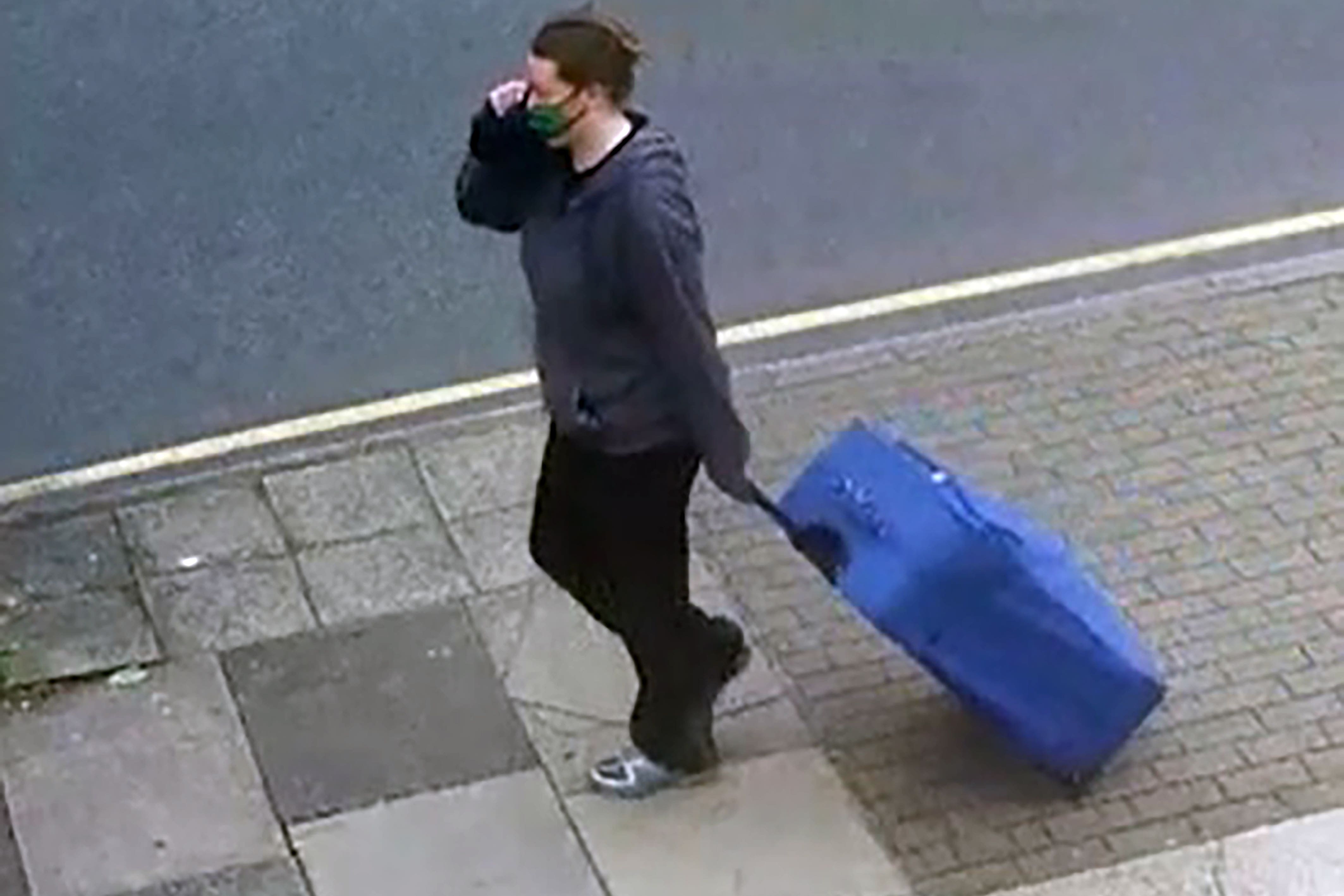 A CCTV image of Jemma Mitchell dragging a blue suitcase in northwest London on 11 June 2021 (Metropolitan Police/PA)