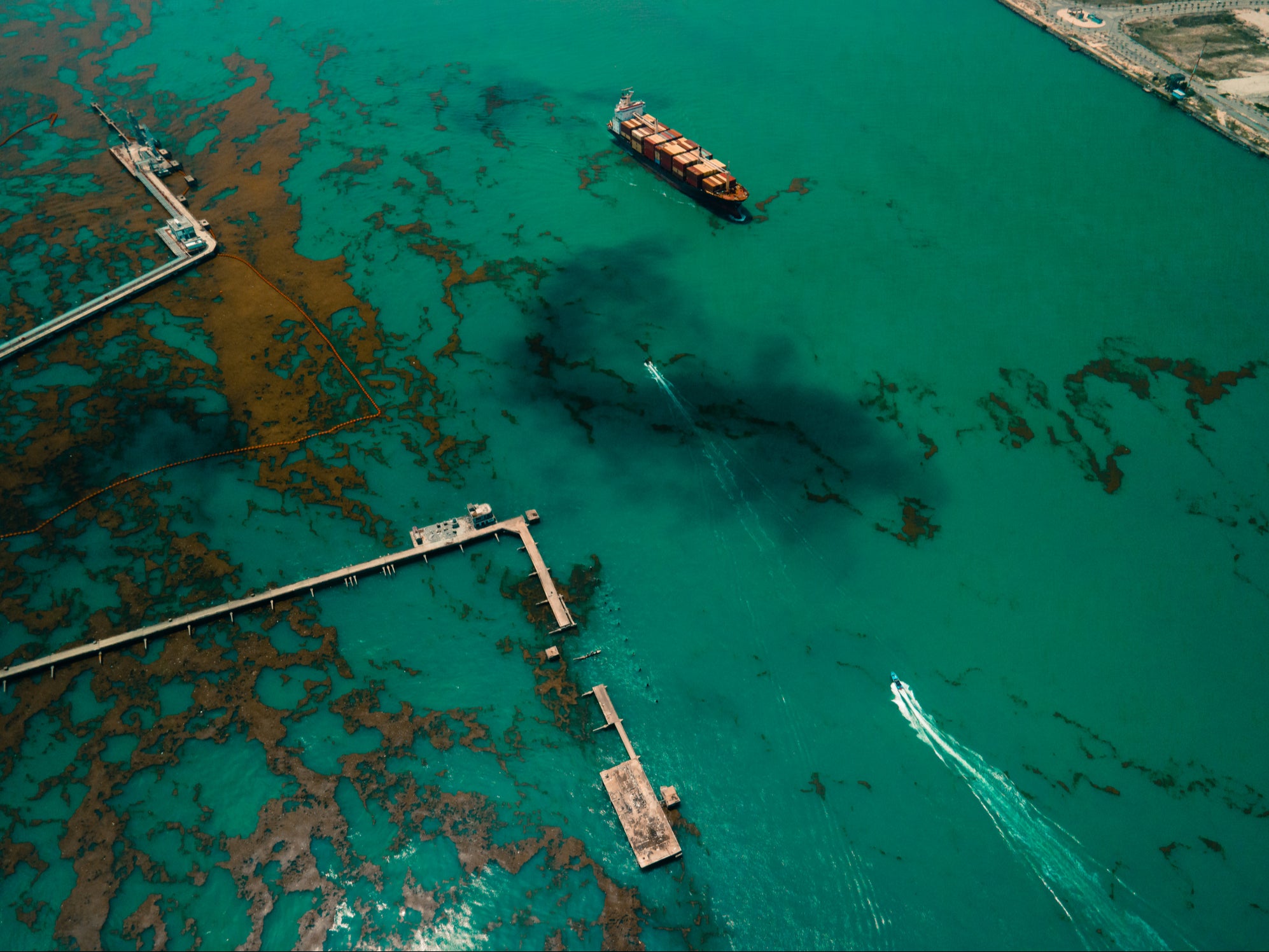 A ship passes an oil spill near an oil depot in Lagos, Nigeria. The country is among those facing the worst ecological threats