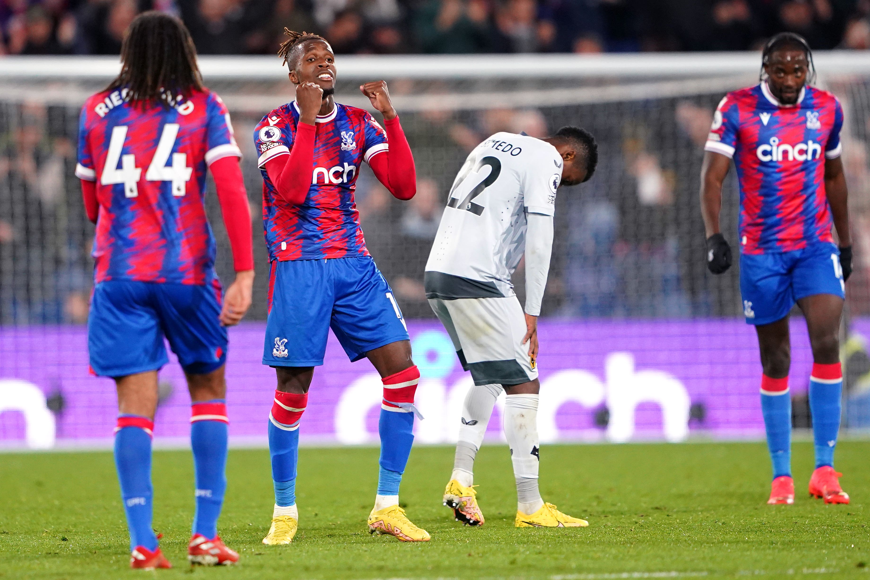 Wilfried Zaha, second left, celebrates victory over Wolves (Zac Goodwin/PA)