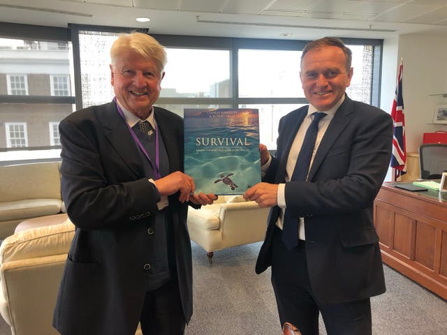 <p>Stanley Johnson presenting his book on Endangered Species to former Defra secretary George Eustice</p>