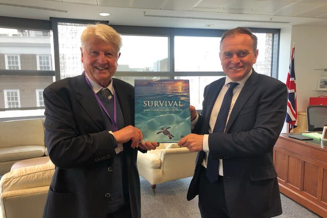 <p>Stanley Johnson presenting his book on Endangered Species to former Defra secretary George Eustice</p>