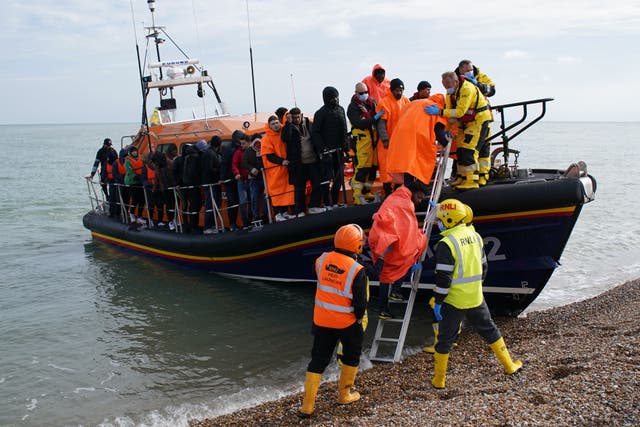 Distressed mothers are throwing their babies at lifeboat crews called out to rescue migrants from flimsy dinghies crossing the Channel, the RNLI said (PA)