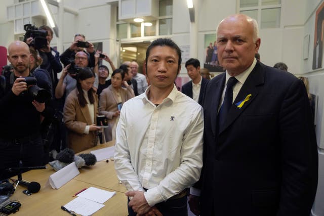 <p>Iain Duncan Smith with Hong Kong protester Bob Chan, who says he was dragged into the Chinese consulate in Manchester and beaten up </p>