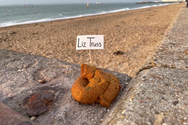 A protest fake poo with a mini flag with Liz Truss written on it placed on the promenade at Southsea, Hampshire (Ben Mitchell/PA)
