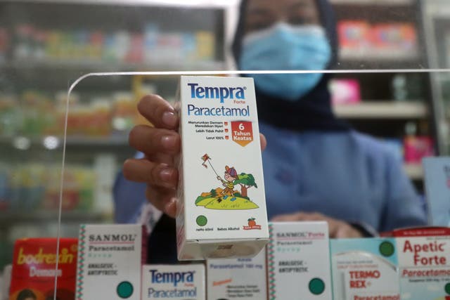 <p>A pharmacist shows a paracetamol syrup for children as it is removed from the shelf in Depok, West Java, Indonesia</p>
