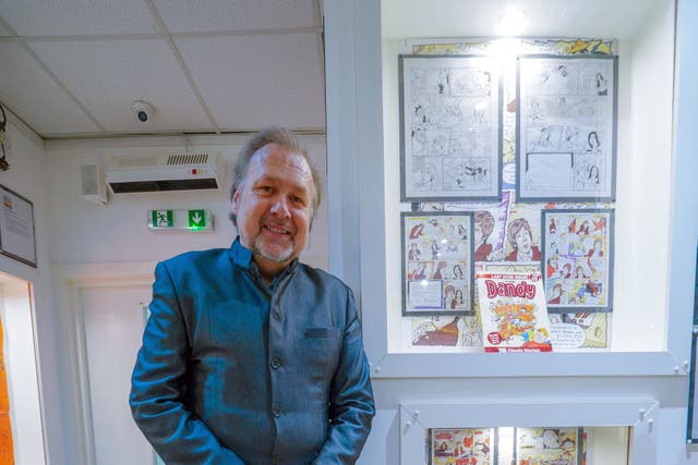 Dandy artist Nigel Parkinson at Liverpool Beatles Museum next to his sketches and artwork of Sir Paul McCartney, who was to appear in an edition of the Dandy (Peter Byrne/PA)