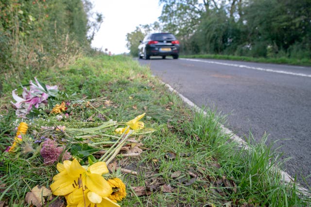Floral tributes on the B4031 outside RAF Croughton, in Northamptonshire, where Harry Dunn, 19, died when his motorbike was involved in a head-on collision (PA)