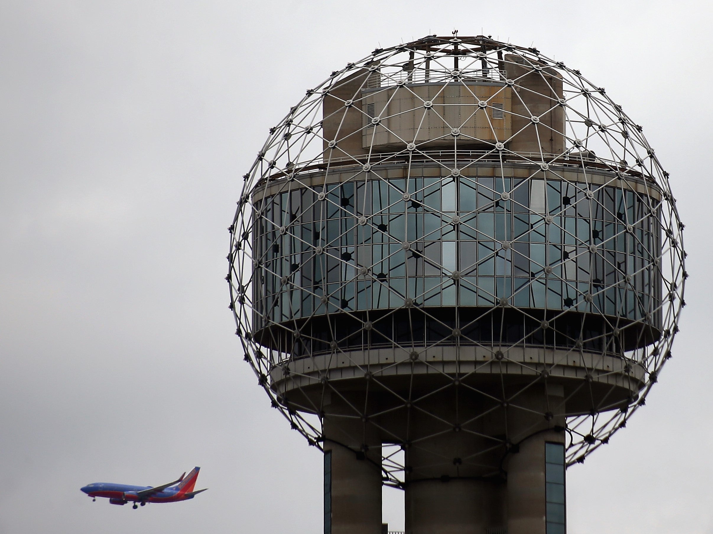 A Southwest Airline plane flies past Reunion Tower on 4 April, 2013 in Dallas, Texas