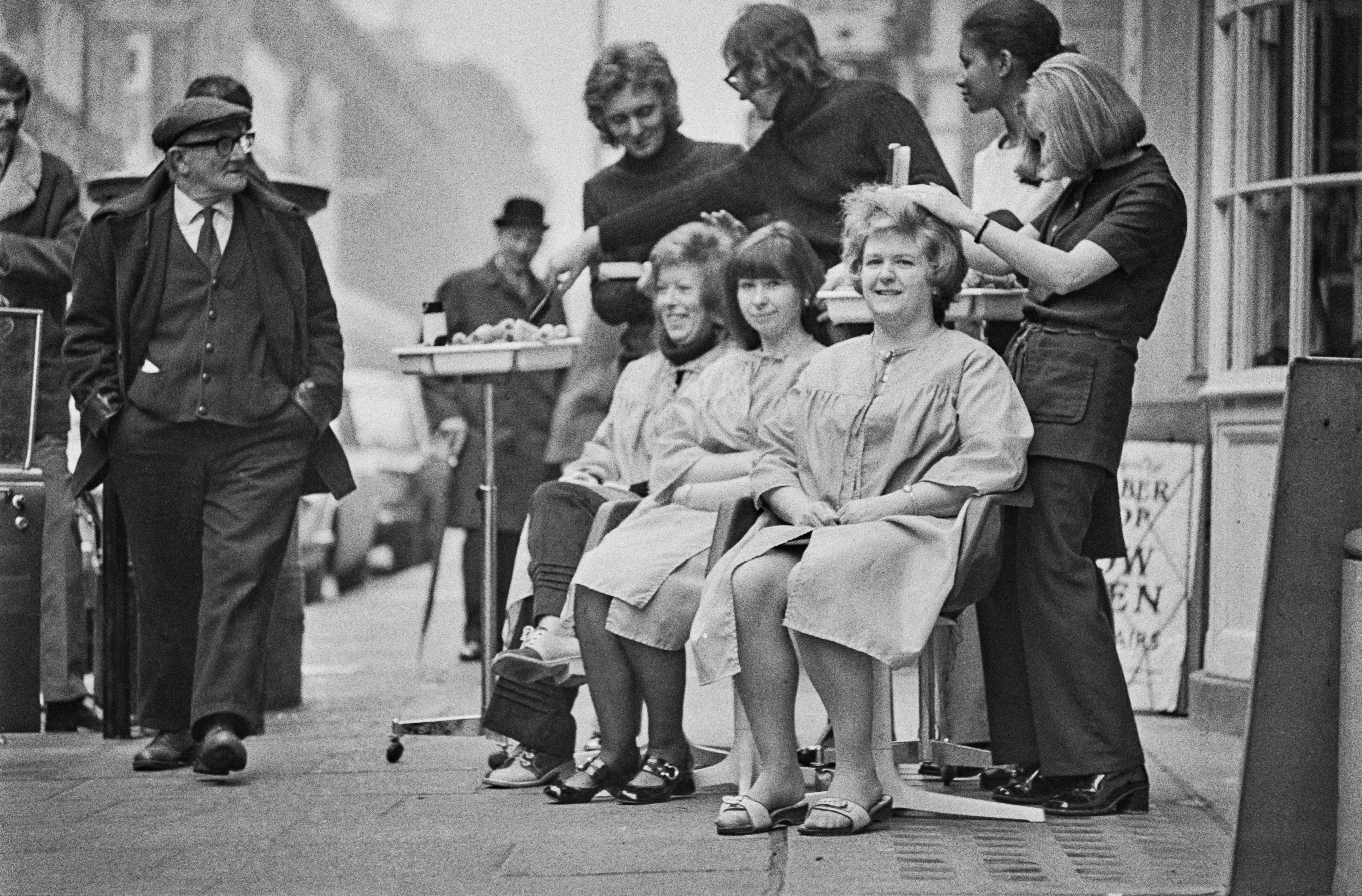 Customers having their hair cut on the pavement in Hatton Garden, London, due to power cuts in 1972