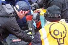 Just Stop Oil protesters glue themselves to tarmac at central London junction