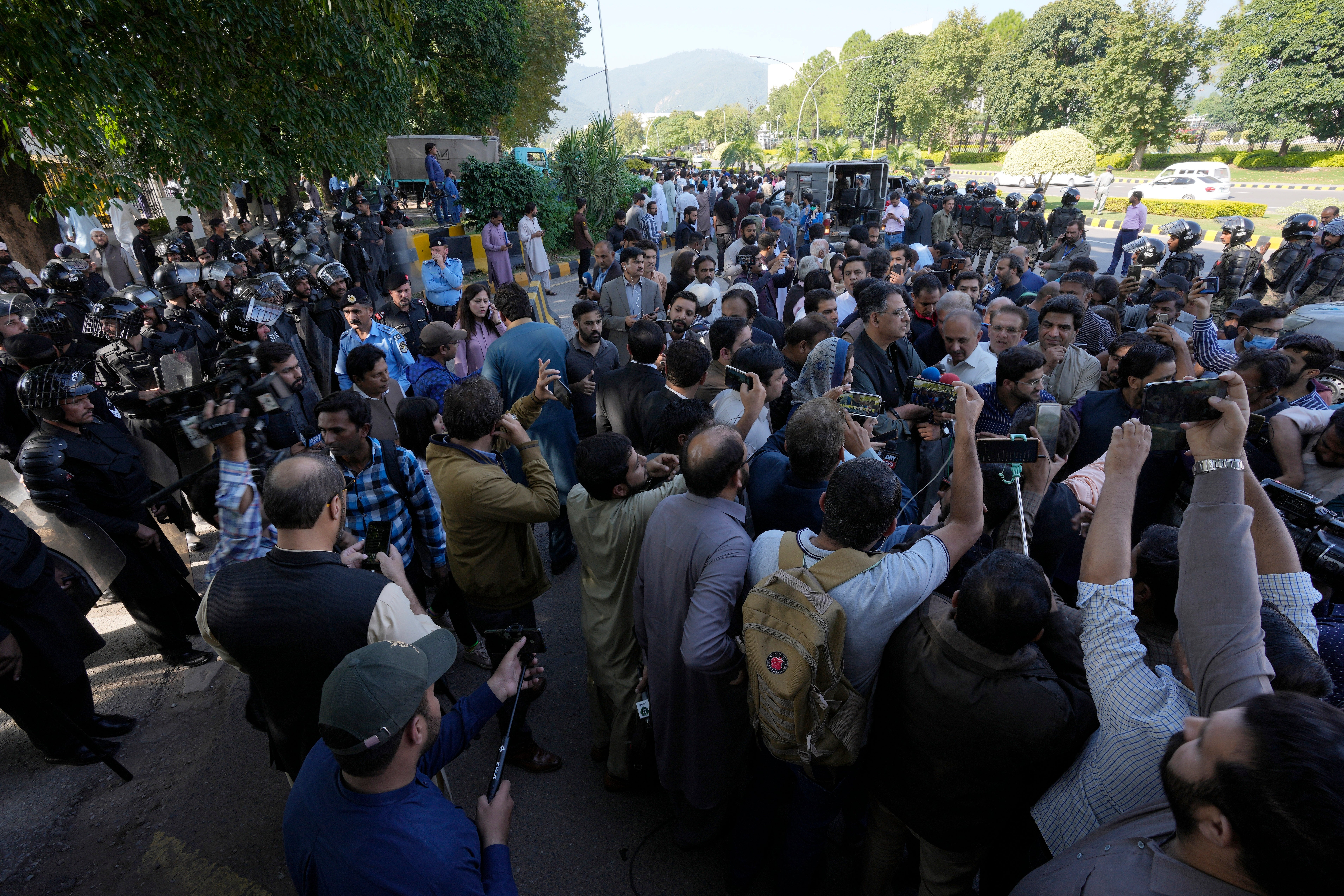 Police attempt to stop supporters of the PTI party from entering the Election Commission head office in Islamabad