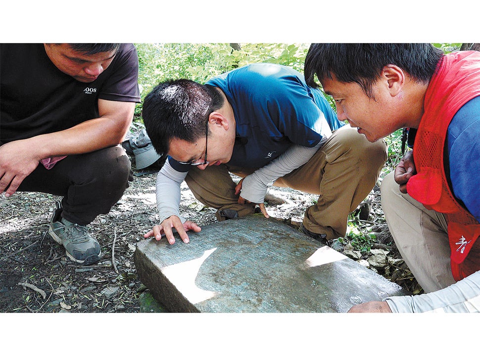 Researchers including Shang Heng (centre) inspect the relics found at the Jiankou section of the Great Wall
