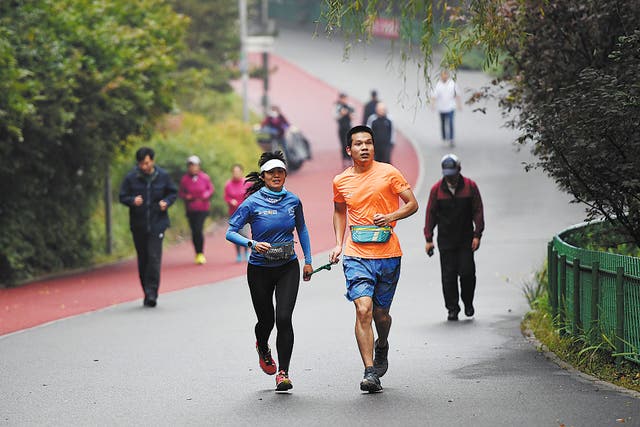 <p>The Beijing branch of Running in the Dark holds regular sessions for members at Olympic Forest Park </p>