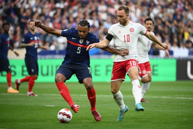 <p>France’s Jules Kounde fights for the ball with Denmark’s Christian Eriksen</p>