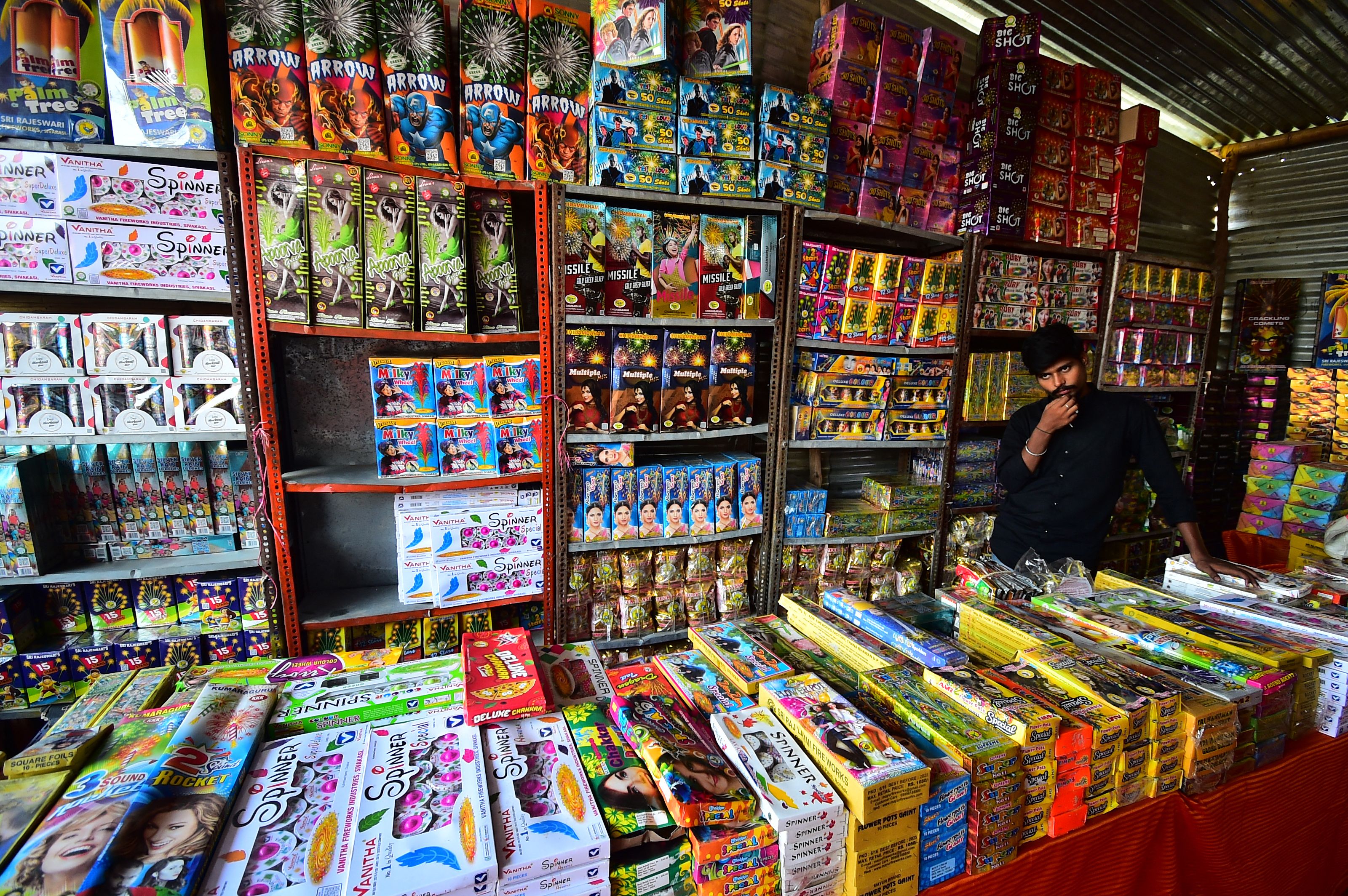File: A vendor selling firecrackers wait for customers at a market ahead of the Hindu festival of Diwali, in Allahabad