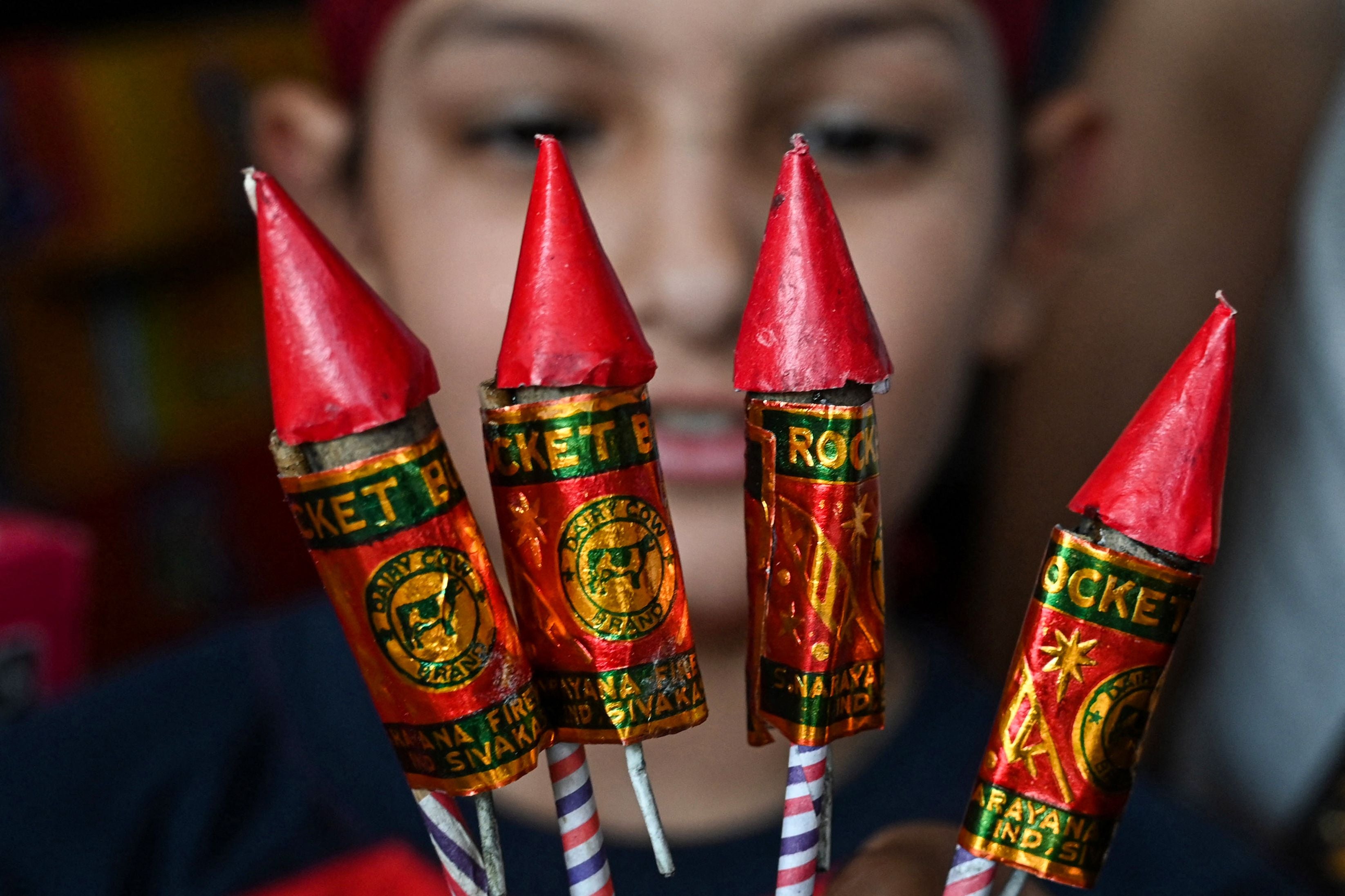 People buy firecrackers on the eve of Hindu festival of Diwali, in Amritsar