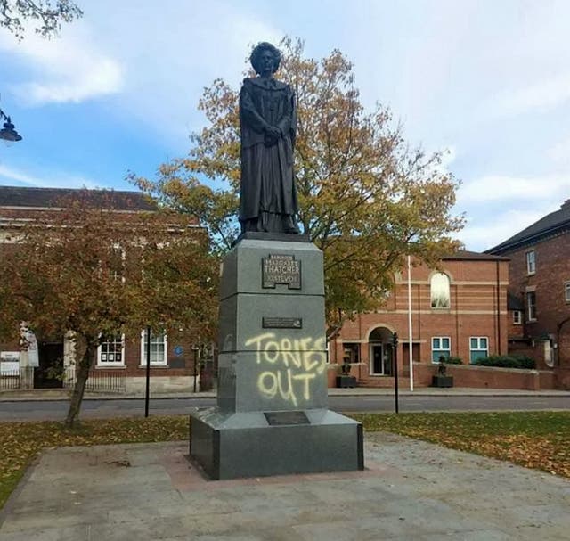 <p>The statue, which sits on St Peter’s Hill, Grantham, has been spray painted with the words “Tories out”</p>