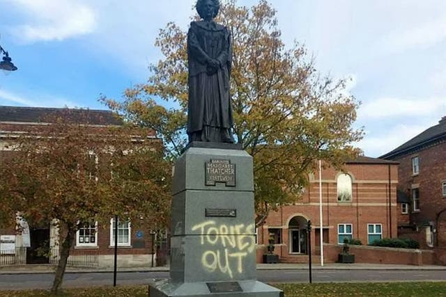 <p>The statue, which sits on St Peter’s Hill, Grantham, has been spray painted with the words “Tories out”</p>