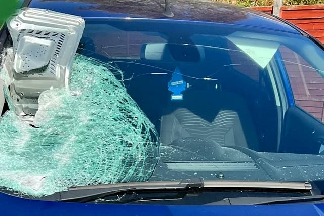 <p>The microwave lodged in the glass, causing the windscreen to shatter </p>
