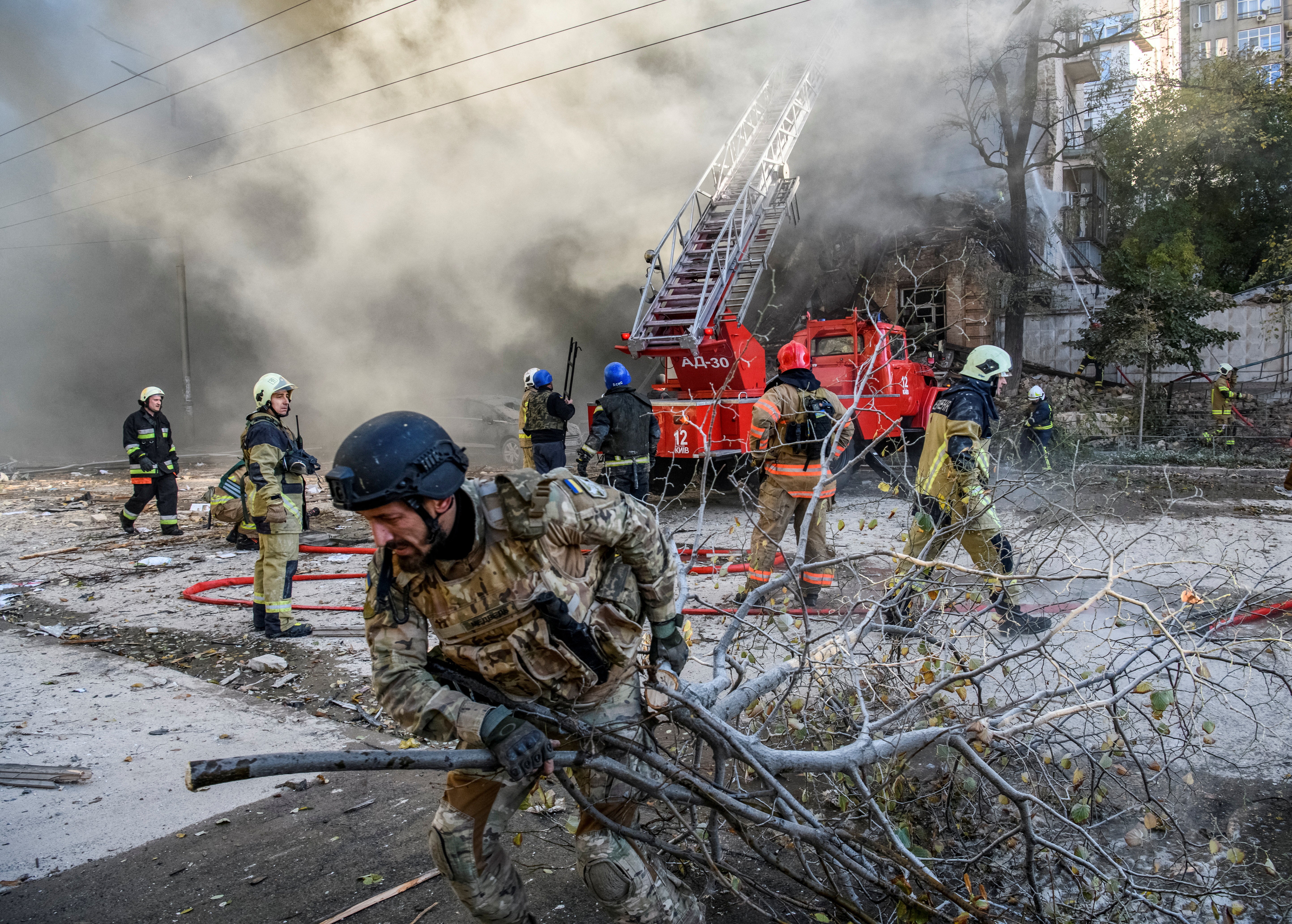 Ukraine firefighters help Kyiv residents after a drone strike last month