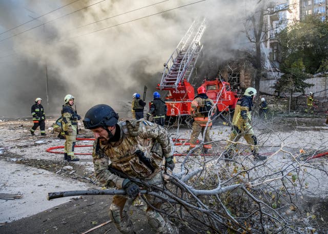 <p>Ukraine firefighters help Kyiv residents after a drone strike last month </p>