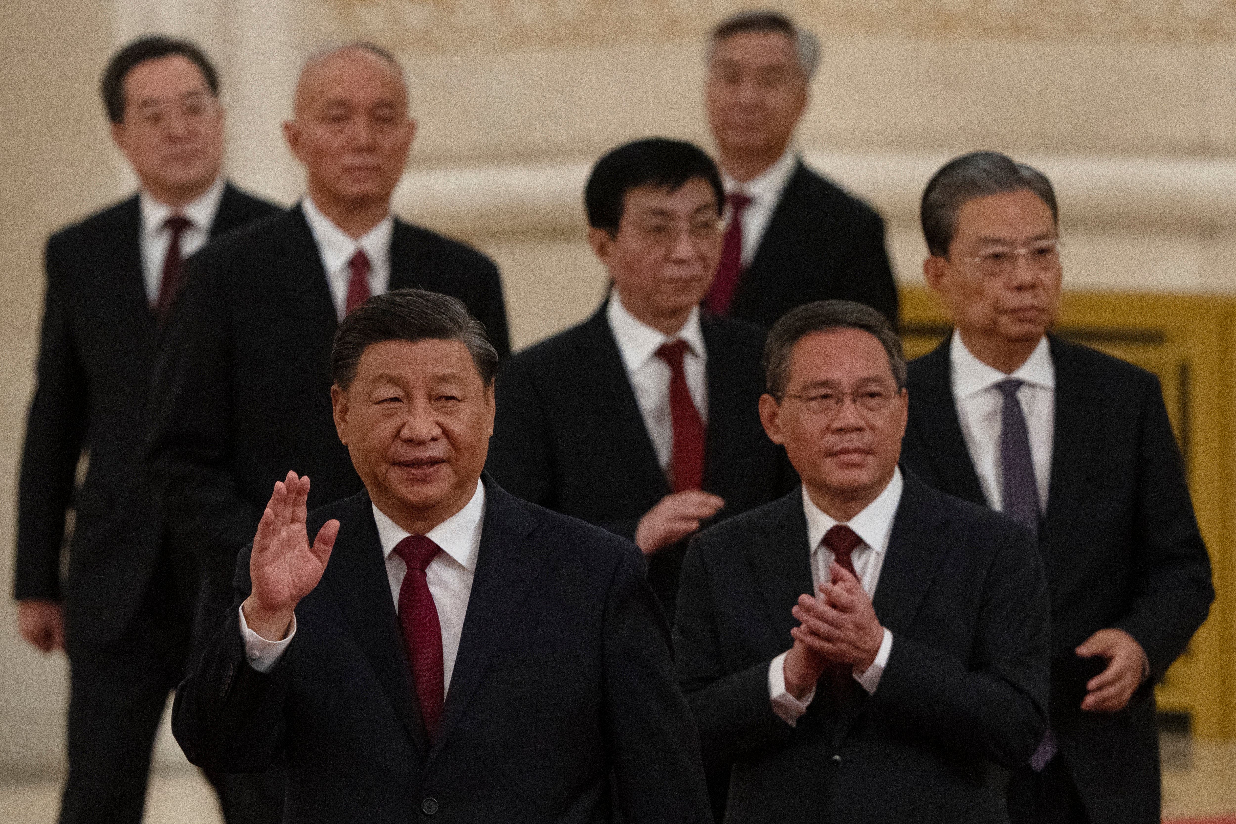 New members of the Politburo Standing Committee (front to back), including President Xi Jinping, Li Qiang, Zhao Leji, Wang Huning, Cai Qi, Ding Xuexiang, and Li Xi arrive at the Great Hall of the People in Beijing on 23 October 2022