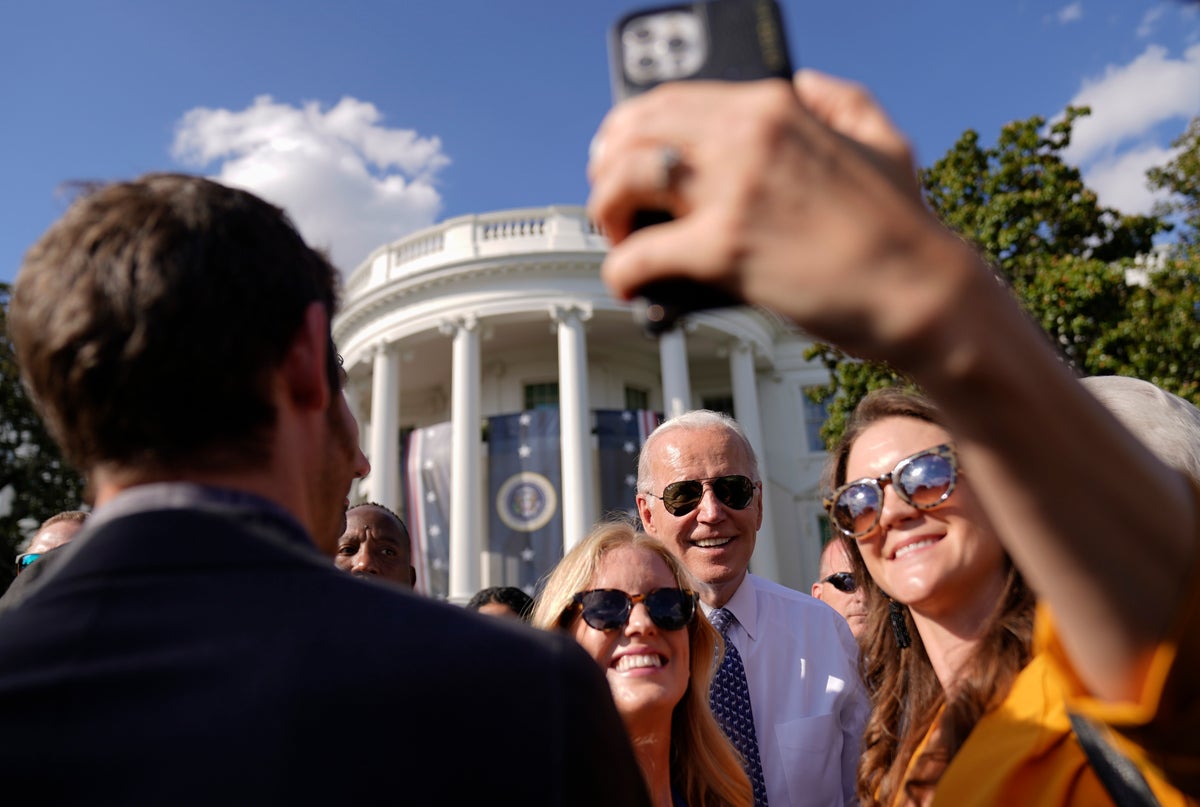 One hug and one selfie at a time, Biden’s mission to connect