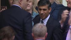 Rishi Sunak greets Tory members as he arrives at Conservative HQ after being named new leader